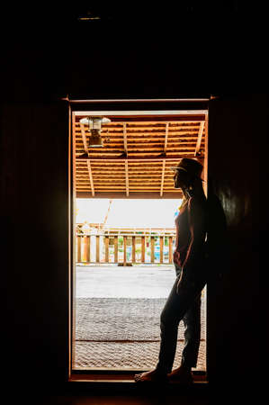 Asian woman at Thai style door, Phayao province.の写真素材