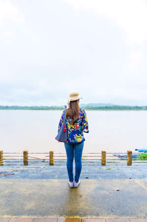 A Woman Traveler with Mekong River Background at Golden Triangle, Chiang Rai Province.の写真素材