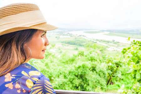 A Woman Traveler with Mekong River Background at Chiang Saen District, Chiang Rai Province.の写真素材