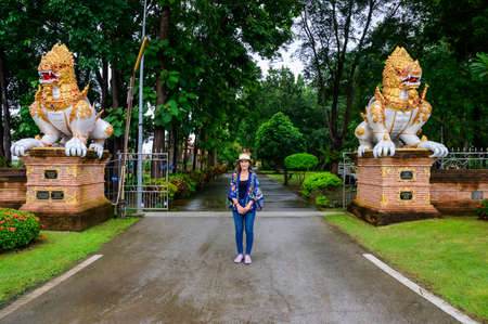 A Woman Traveler with Wat Phra That Song Pee Nong Background at Chiang Saen District, Chiang Rai Province.の写真素材