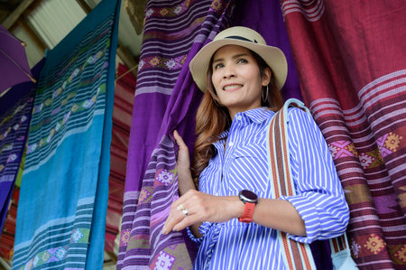 Thai Girl in Blue Dress with Thai Cloth background.の写真素材