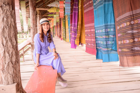 Thai Girl in Blue Dress with Thai Cloth background.の写真素材