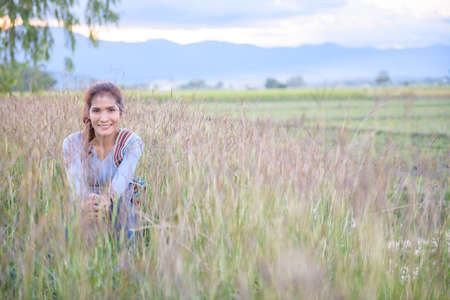 A woman is sitting in the rice field, Phayao province.の写真素材