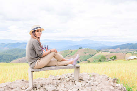 Asian Woman with Rice Field Background at Pa Bong Piang Rice Terraces, Chiangmai Province.の写真素材
