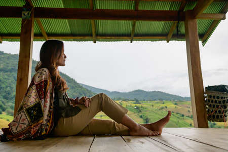Asian Woman in Thai Native Pavilion with Rice Field Background at Pa Bong Piang Rice Terraces, Chiangmai Province.の写真素材