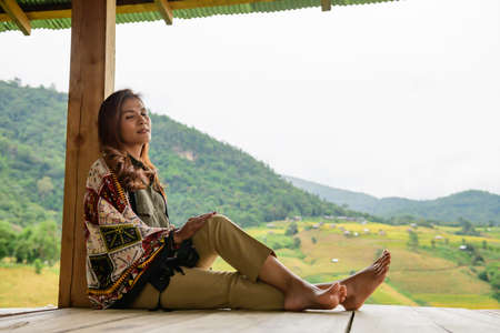 Asian Woman in Thai Native Pavilion with Rice Field Background at Pa Bong Piang Rice Terraces, Chiangmai Province.の写真素材