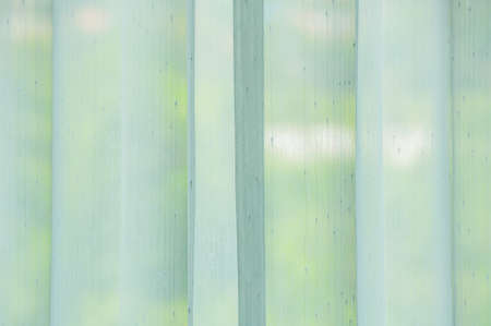 White sheer curtains hanging on the window, Thailand.の写真素材