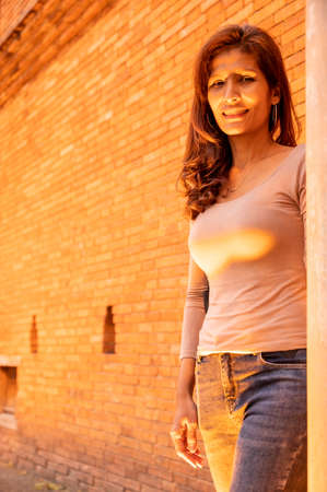 Thai woman with old brick wall in the evening, Chiang Mai.の写真素材