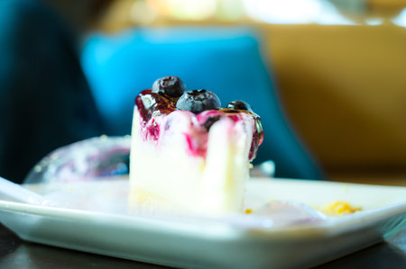 Blueberry Cheesecake on white plate at coffee shopの写真素材