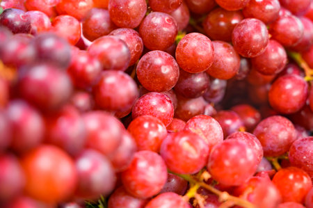 Background of ripe red grapes on a fresh market stall stall at Nakhon Sawan province, Thailand.の写真素材