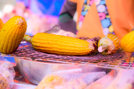 Grilled corn on the stove, It is a food that Thai people like to eat. And also commonly sold on stalls at flea markets, Thailand.の写真素材
