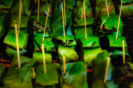 Sour pork in banana leaves on the grill, local food of the northern region in Thailand.