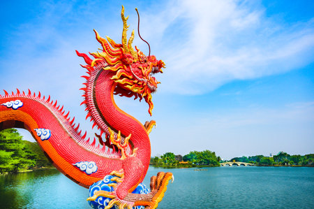Red dragon statue and lake view in Nakhon Sawan Province, Thailand.の写真素材