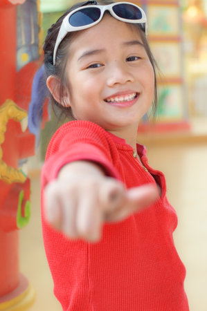 Asian girl in red dress with Chinese style backgroundの写真素材