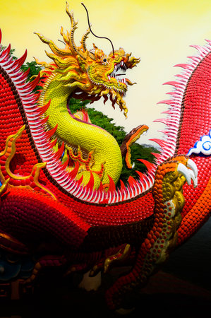 Yellow dragon statue with yellow sky background, Nakhon Sawan province.の写真素材