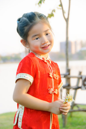 Little Asian girl in Chinese traditional dress during Chinese New Year festival.の写真素材