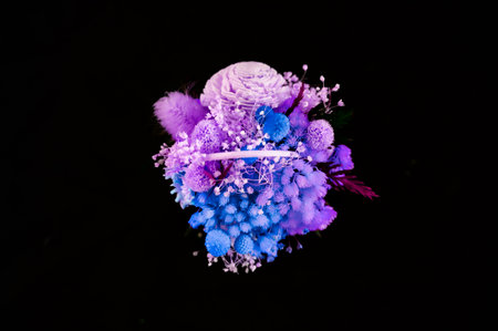 Dried flowers in a small wicker basket and black backgroundの写真素材