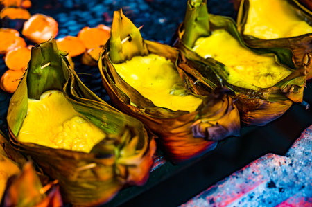 Grilled Eggs with Banana Leaves or Khai Pam on charcoal stove at Chiang Mai Province. This food is a...