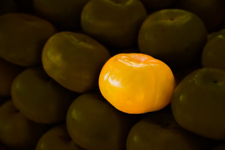 Pile of persimmons. Stock of persimmons. Background of persimmons. Organic persimmon fruit. This...