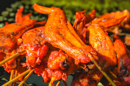 Food Series : Chicken wings grilled on the charcoal stove. Thai style grilled chicken wings. Thai...