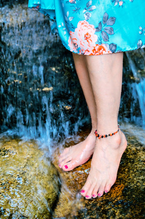 Human Body Series : Woman feet amidst natural waterfalls in Chiang Mai. A pair of girl feet rested...