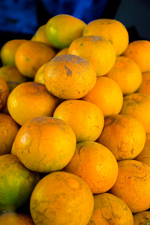 Food Series : Fresh oranges on a fruit stand. Tangerine background. Vegetarian food. Fresh oranges backdrop. Vegan food concept. Vegetarian food. Fruit texture.の写真素材