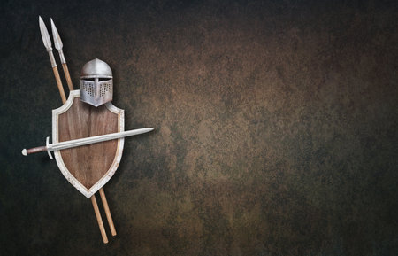 knight's helmet sword wooden shield and two spears on dark grunge backgroundの写真素材