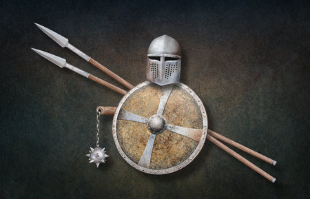 knight's helmet chain mace shield decorated with a iron cross and two spears on grunge backgroundの写真素材