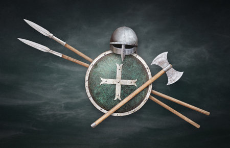 viking helmet axe round shield with metal cross and two spears on grunge backgroundの写真素材
