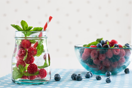 Fresh raspberry mojito with berries on a white polka-dotted backgroundの写真素材