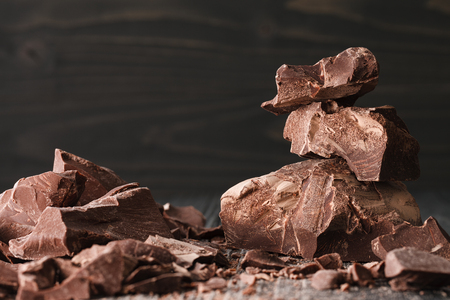Handmade chocolate pieces on a dark wooden backroundの写真素材
