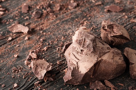 Handmade chocolate pieces on a dark wooden backroundの写真素材