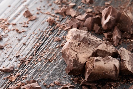 Handmade chocolate pieces on a dark wooden backgroundの写真素材