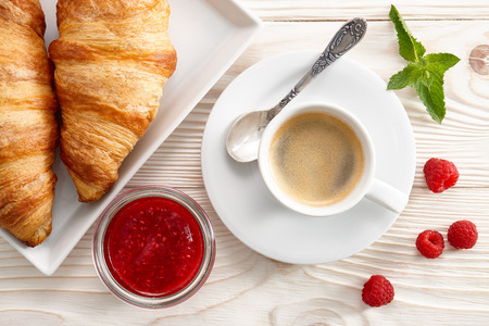 Morning breakfast with espresso coffee, raspberry jam and fresh croissants.の写真素材
