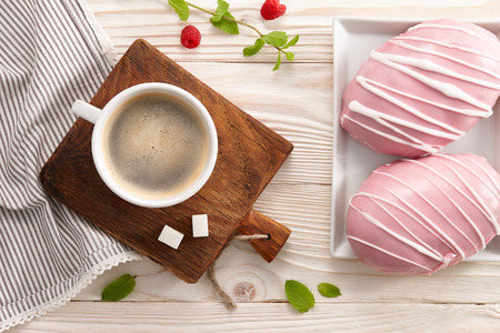 Morning breakfast with americano coffee, raspberry and fresh glazed bans.の写真素材