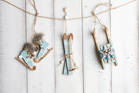 Wooden christmas decorations hanging over white fenceの写真素材