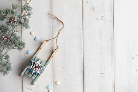 Wooden sledge christmas decoration on white boardsの写真素材