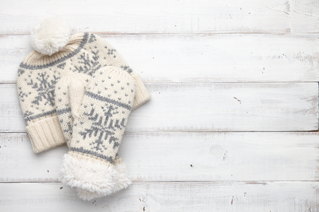 Winter background with knitted mittens and capの写真素材