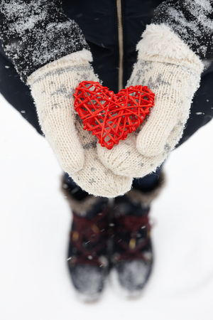 Rattan red heart in handsの写真素材