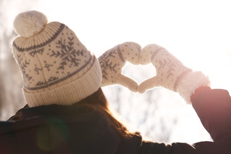 Woman holding hands in a heart shapeの写真素材