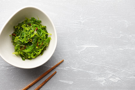 Japanese chuka wakame salad with seaweed and sesame seeds on stone backgroundの写真素材