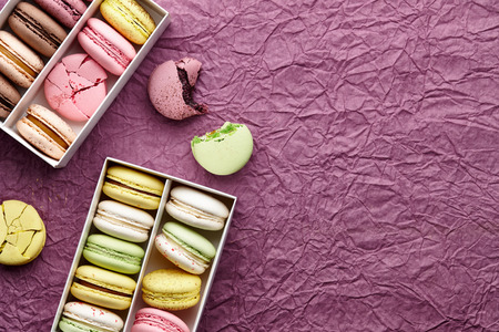 Macarons on creased paper textured background, space for textingの写真素材