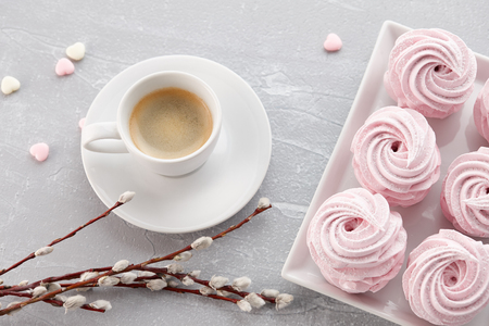 Cup of espresso coffee and homemade zephyr or marshmallow in a white plate on stone backgroundの写真素材