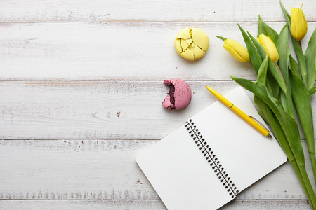 Feminine workspace with macarons and tulipsの写真素材