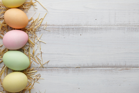 Colorful Easter eggs on white wooden backgroundの写真素材