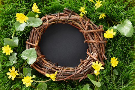 Spring composition with wreath or bird nest in flowering meadow, copy spaceの写真素材