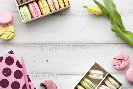 Feminine workspace with macarons and tulipsの写真素材
