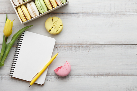 Feminine workspace with macarons and tulipsの写真素材