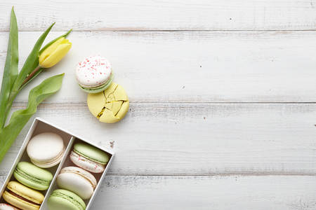 Yellow tulips and a box of macaronsの写真素材