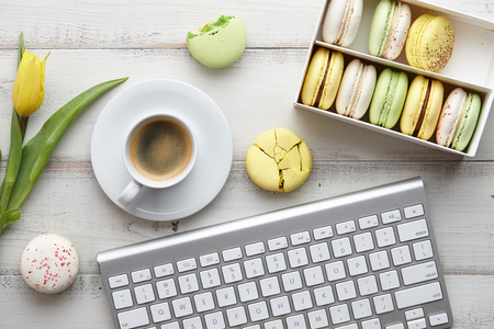 Feminine workspace with macarons and tulipsの写真素材